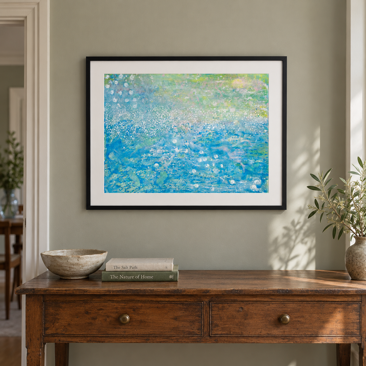 Illustrative room mockup — The Story of the Secret Seahorse in a black frame above a wooden console