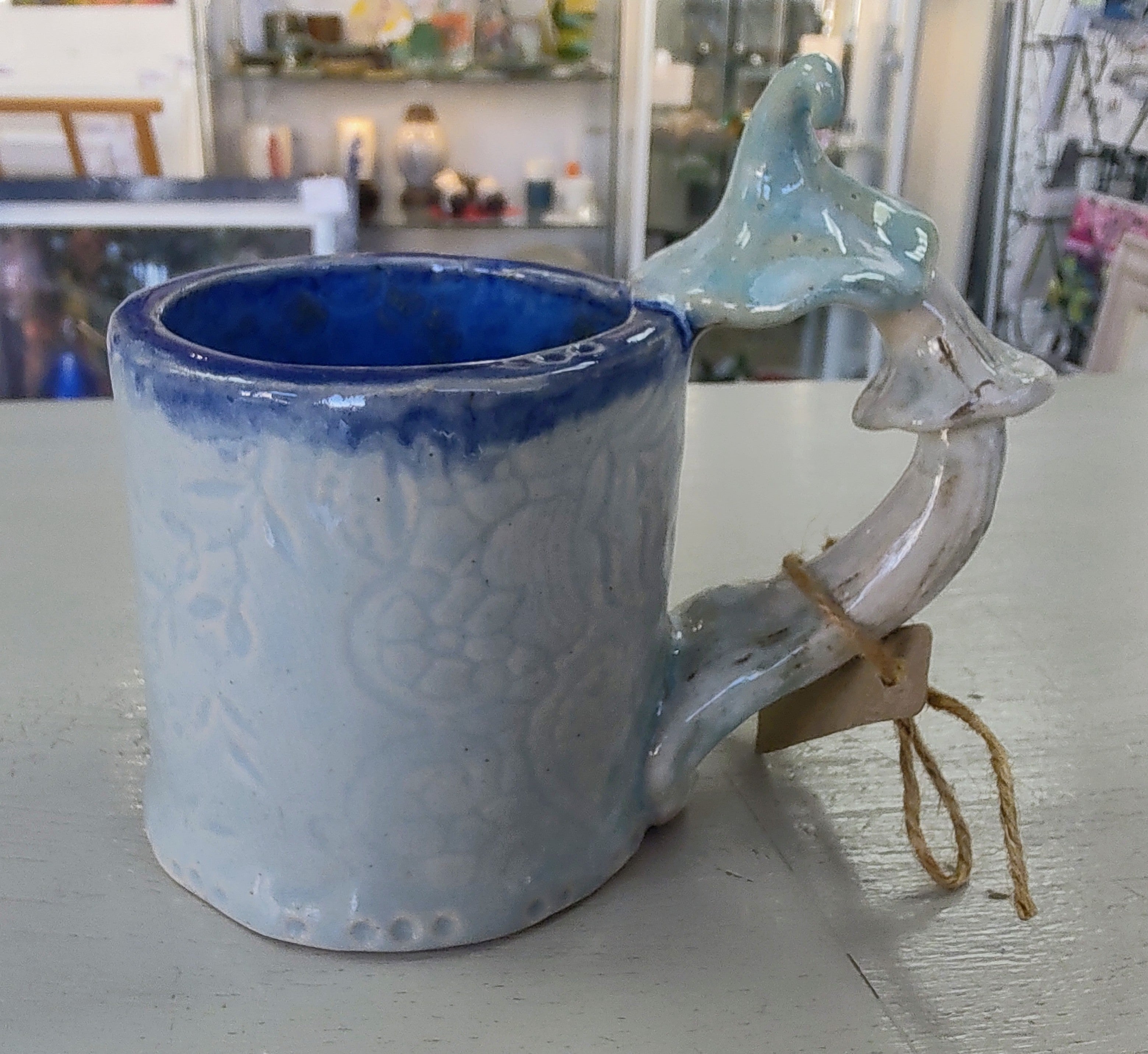 Marika Du Plessis- Toadstool Coffee Cup, Pale Blue - Primrose Gallery and Framing 